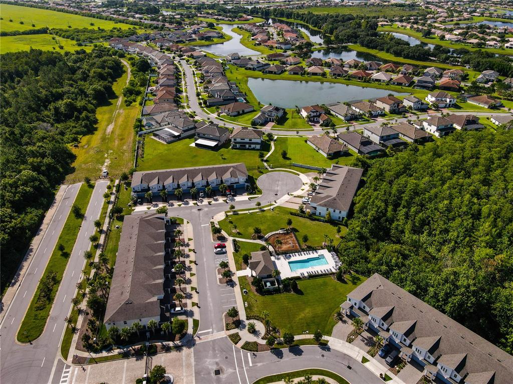 3470 Beau Road Kissimmee, FL 34746 - Photo 39 of 40 an aerial view of a city with lots of residential buildings ocean and mountain view in back