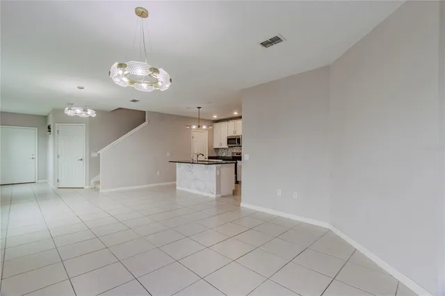 an empty room with kitchen and stove