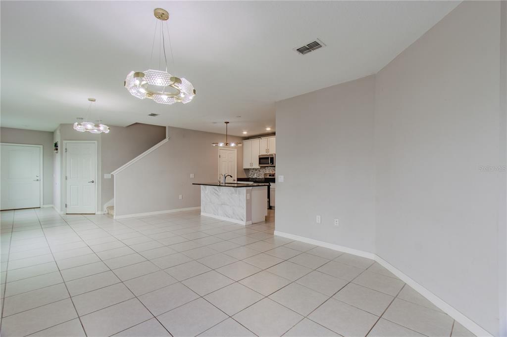 3470 Beau Road Kissimmee, FL 34746 - Photo 8 of 40 an empty room with kitchen and stove