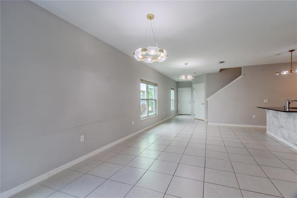 3470 Beau Road Kissimmee, FL 34746 - Photo 9 of 40 a view of an empty room with window and chandelier fan
