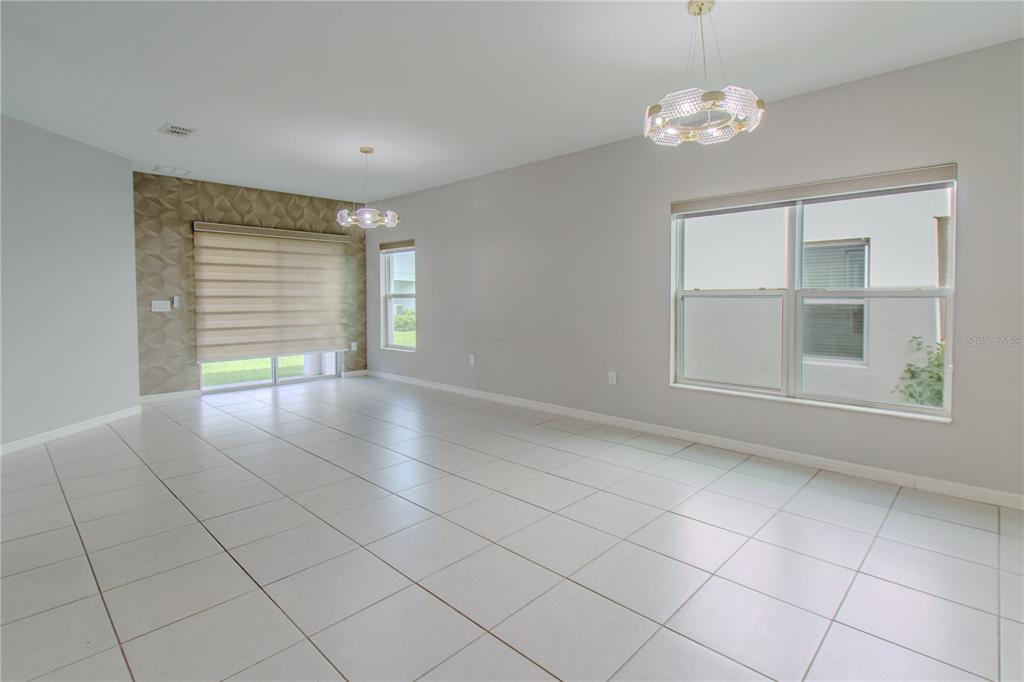 3470 Beau Road Kissimmee, FL 34746 - Photo 10 of 40 an empty room with windows and chandelier