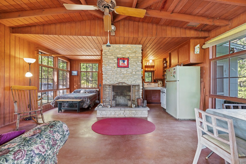181 Ranch Road 1 Stonewall, TX 78671 - Photo 5 of 18 a living room with furniture a fireplace and a table