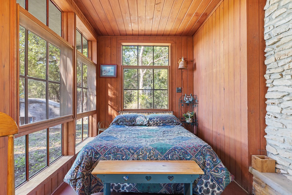 181 Ranch Road 1 Stonewall, TX 78671 - Photo 7 of 18 a large bed in a bedroom next to a window