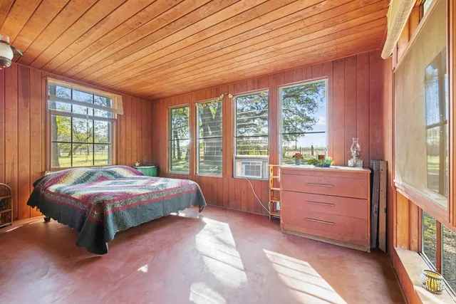 a bed room with a bed and a large window