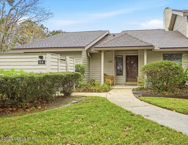 a front view of a house with a yard and porch