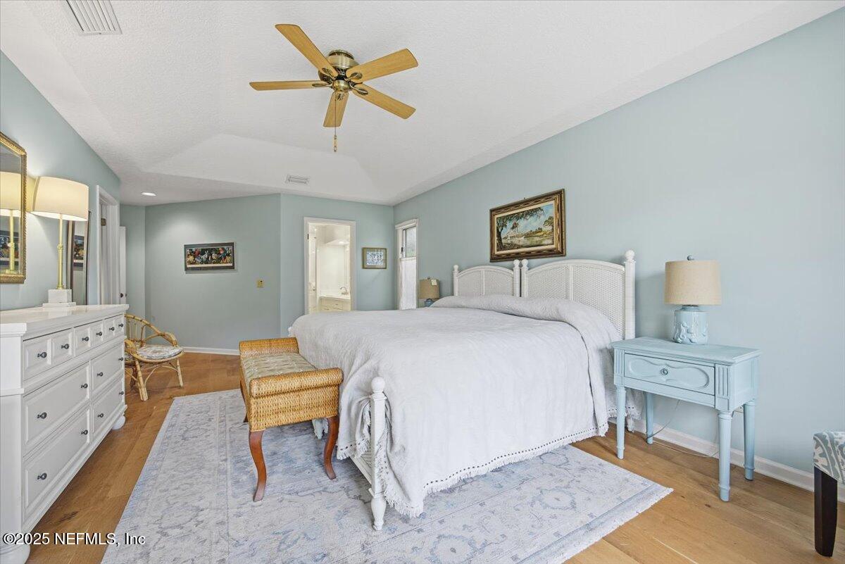 84 Players Club Villas Road Ponte Vedra Beach, FL 32082 - Photo 12 of 20 a bedroom with a bed and a chandelier