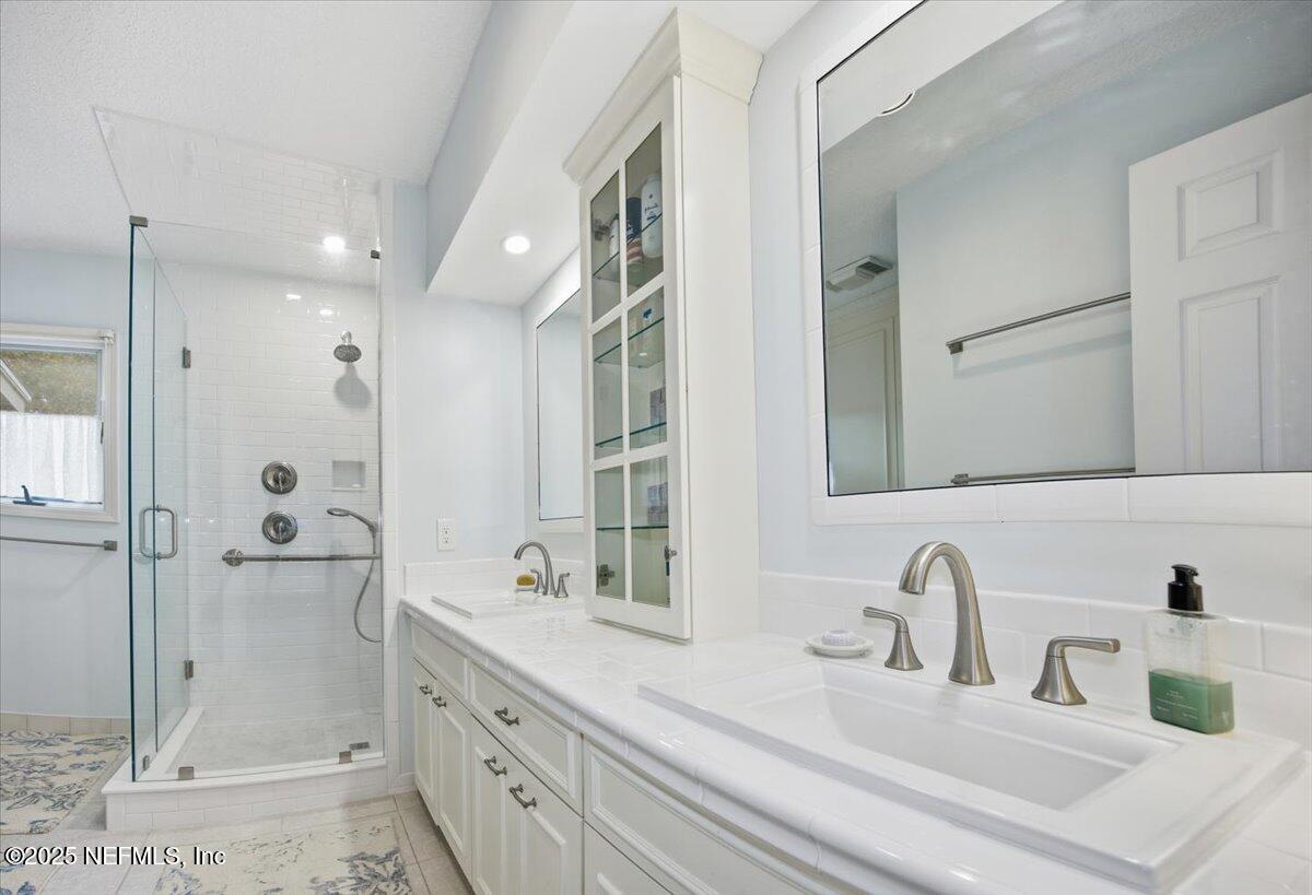 84 Players Club Villas Road Ponte Vedra Beach, FL 32082 - Photo 13 of 20 a bathroom with a double vanity sink mirror and shower