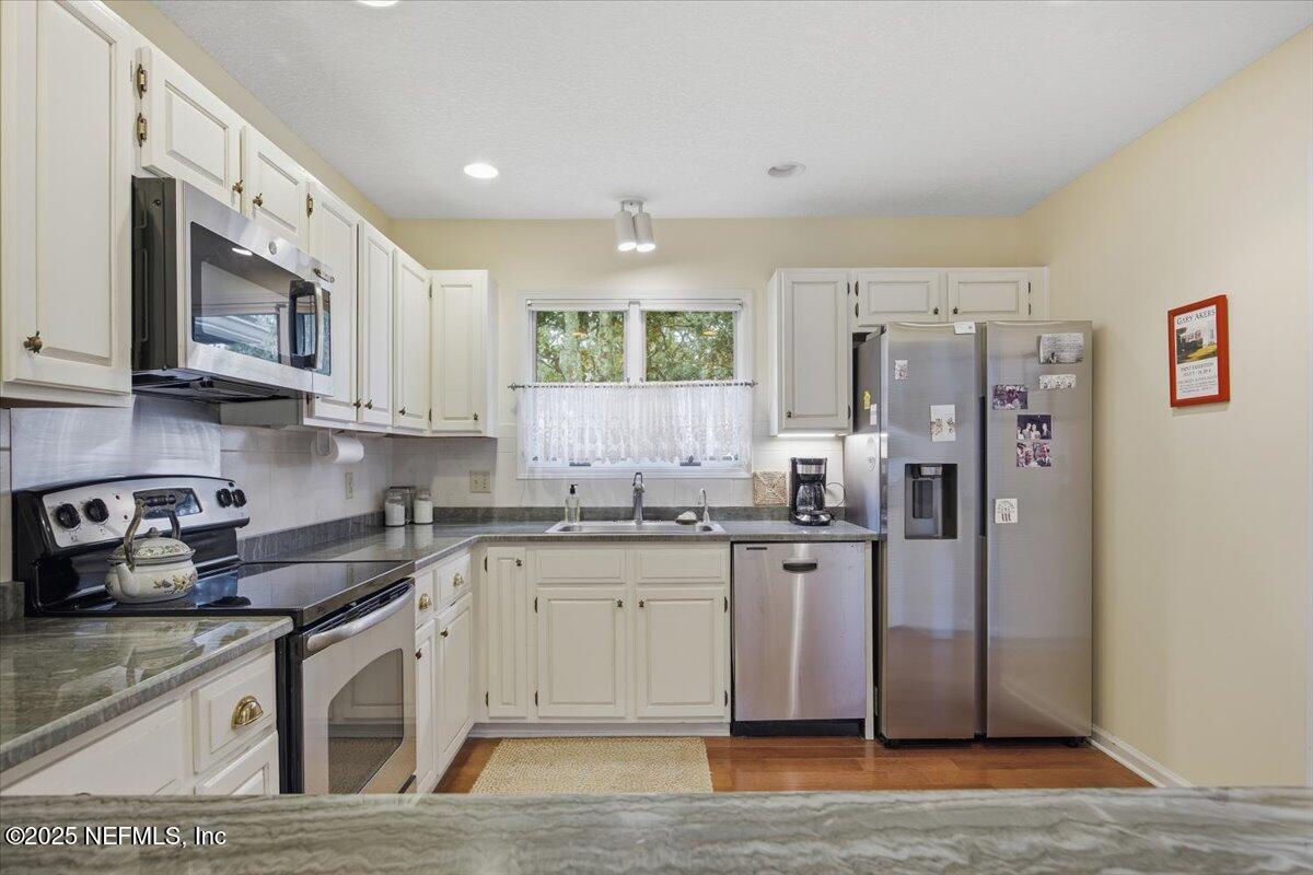 84 Players Club Villas Road Ponte Vedra Beach, FL 32082 - Photo 5 of 20 a kitchen with stainless steel appliances granite countertop a stove a sink and a refrigerator