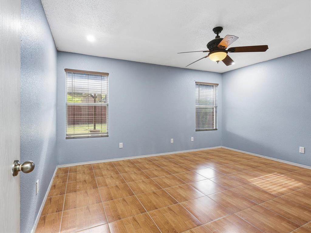 918 Blue Sky Drive Arlington, TX 76002 - Photo 15 of 24 a bedroom with a bed and a chandelier