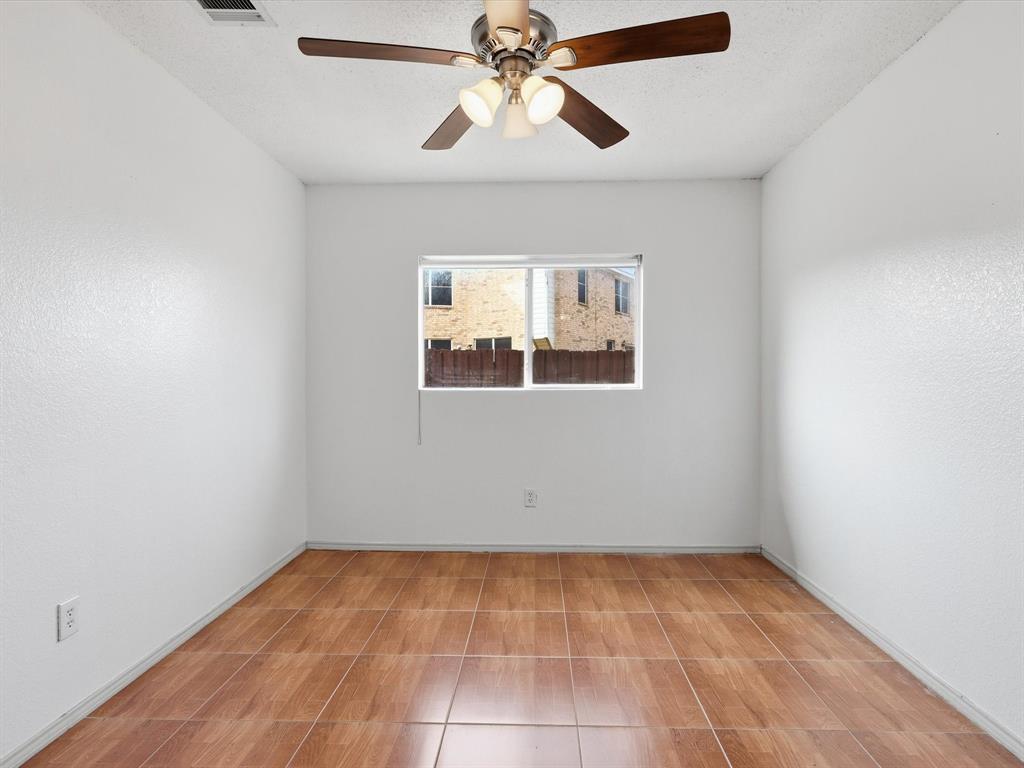 918 Blue Sky Drive Arlington, TX 76002 - Photo 20 of 24 an empty room with a window and a chandelier fan