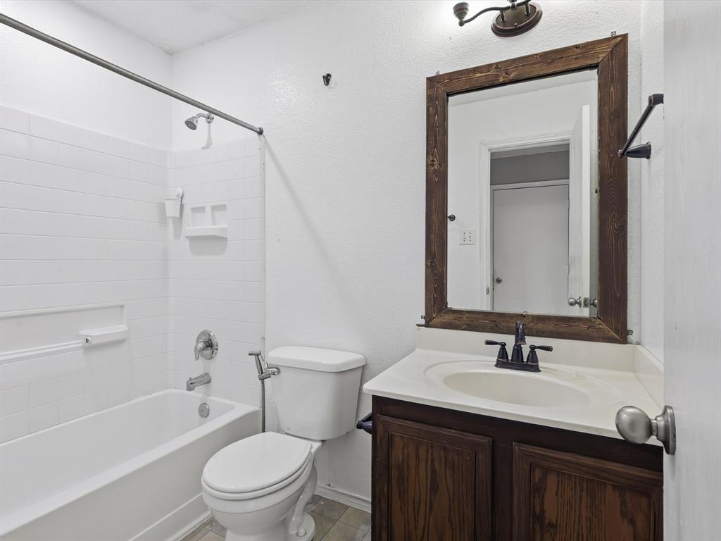 918 Blue Sky Drive Arlington, TX 76002 - Photo 21 of 24 a bathroom with a granite countertop sink toilet and shower