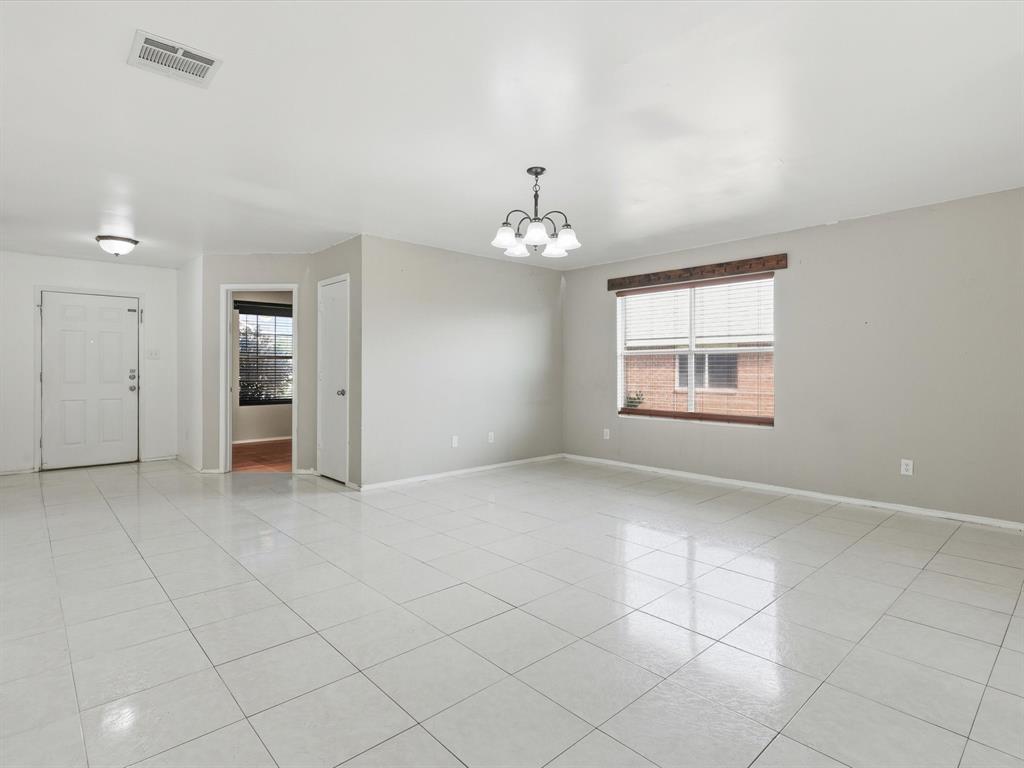 918 Blue Sky Drive Arlington, TX 76002 - Photo 4 of 24 an empty room with chandelier and windows