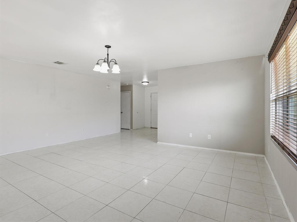 918 Blue Sky Drive Arlington, TX 76002 - Photo 5 of 24 an empty room with chandelier fan and windows