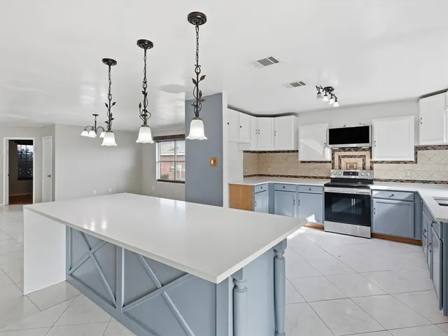 a kitchen with a stove a sink and a refrigerator