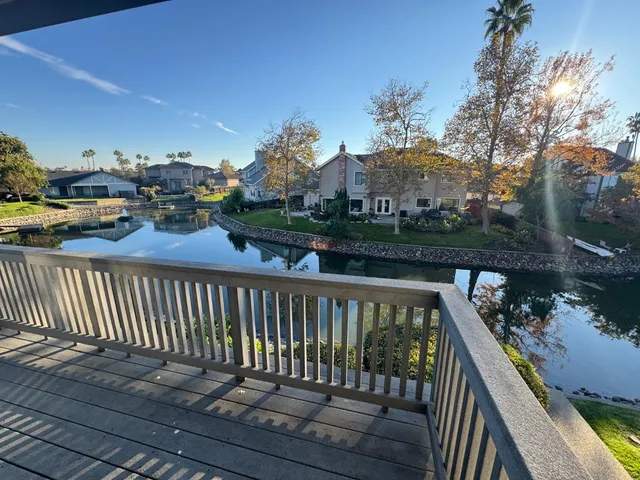 a view of a balcony with wooden fence