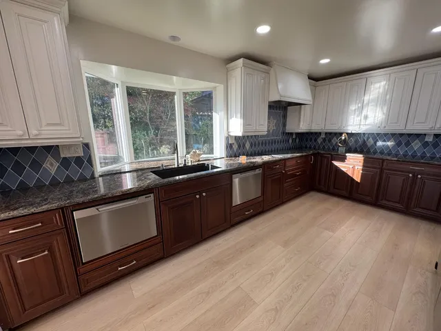 a large kitchen with granite countertop lots of counter top space