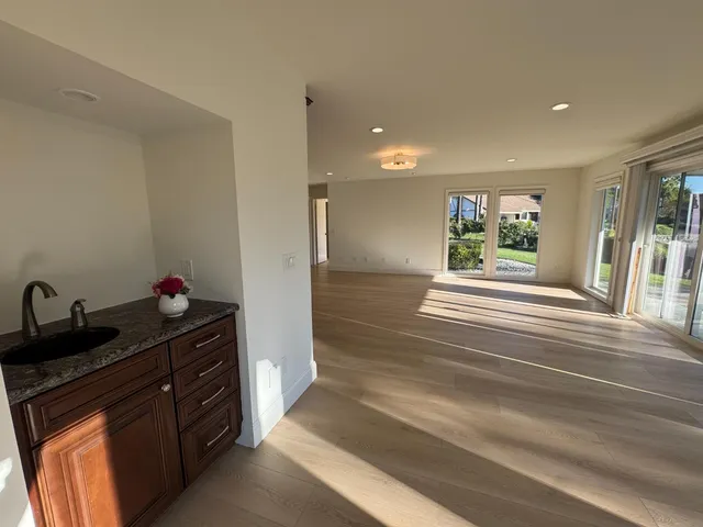 a living room with furniture and a mirror