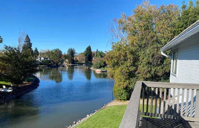 a view of a wooden deck with lake view