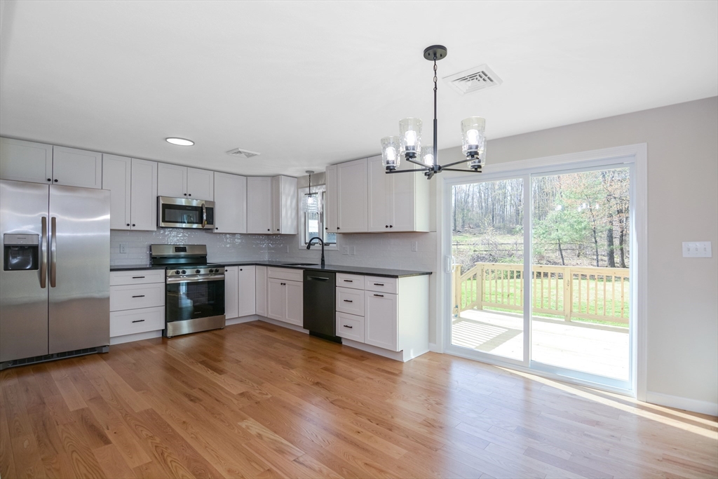 21 North End Road Townsend, MA 01469 - Photo 3 of 39 a kitchen with stainless steel appliances a refrigerator sink and microwave