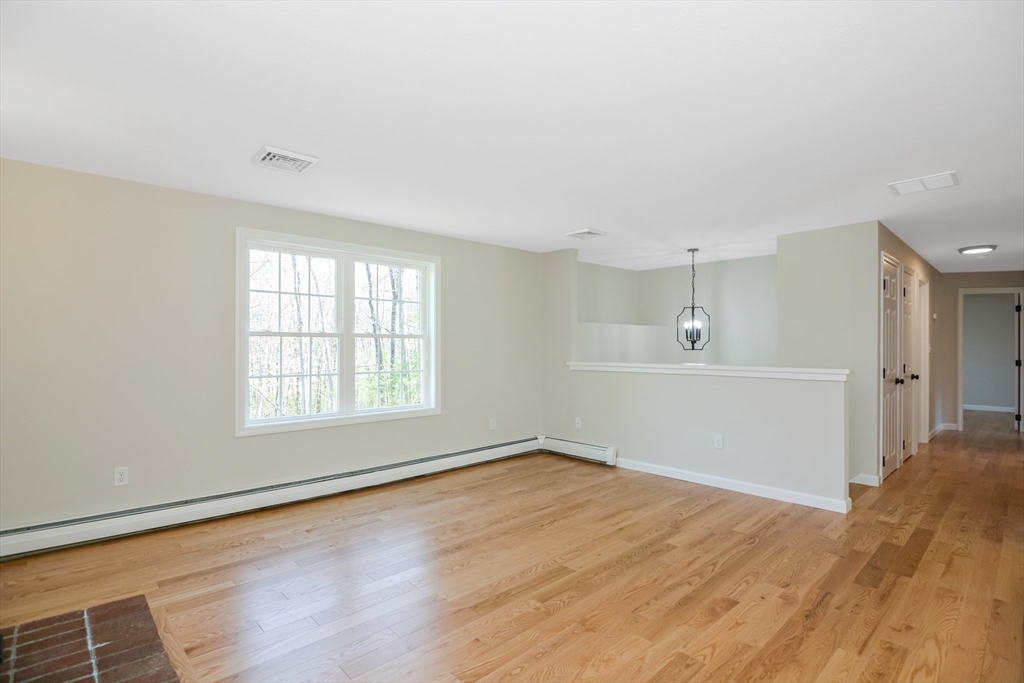 21 North End Road Townsend, MA 01469 - Photo 6 of 39 a view of empty room with wooden floor and fan