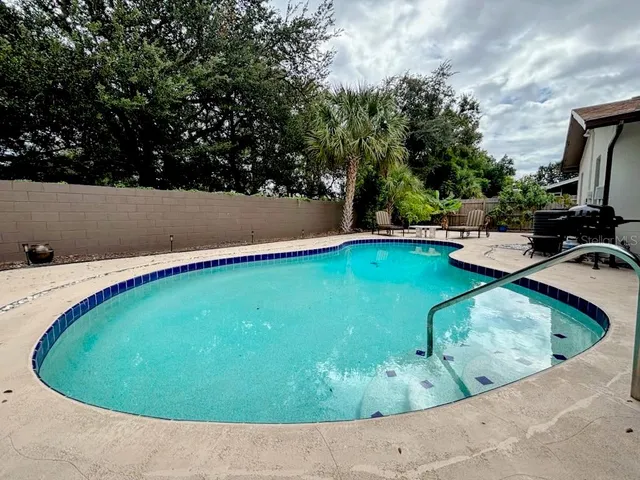 a view of a swimming pool with a yard