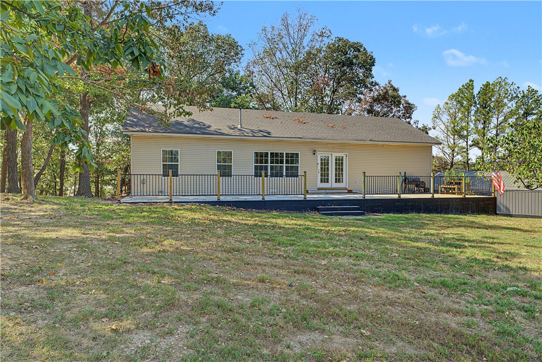 15282 Burgin Valley Road Gravette, AR 72736 - Photo 34 of 53 Rear exterior with a spacious deck, dual French doors, multiple windows, siding facade, and a shingled roof