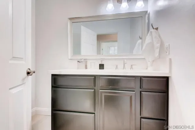 a bathroom with a tub sink shower and mirror