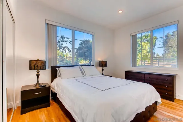 a bathroom with a sink a toilet and a large mirror