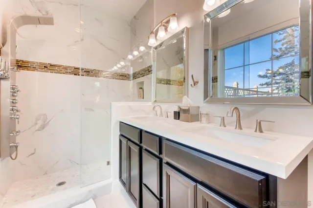 a bedroom with two beds and a flat screen tv