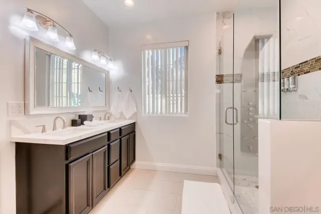 a bedroom with two beds and a ceiling fan