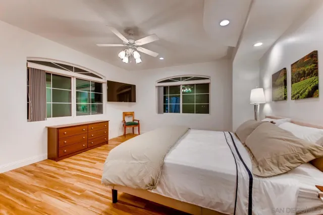 a bathroom with a granite countertop sink a toilet and a mirror