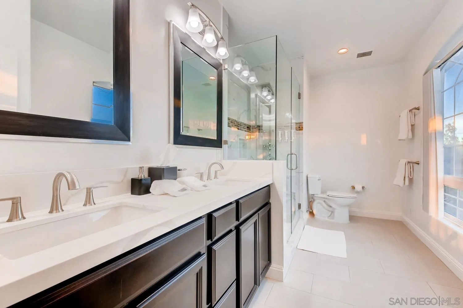 39575 Ave Ascencion Temecula, CA 92592 - Photo 29 of 68 a bathroom with a sink a toilet and a large mirror