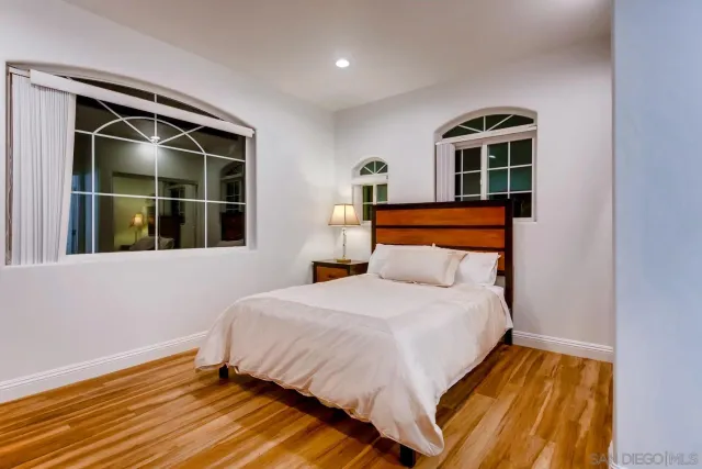 a bed room with a bed and a chair