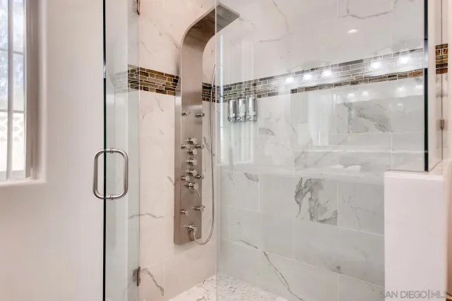 a living room with furniture a flat screen tv and a large window