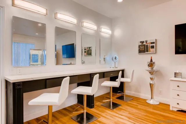 an outdoor sitting area with furniture and wooden floor