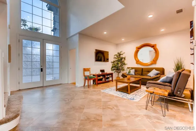a view of a house with swimming pool and sitting area