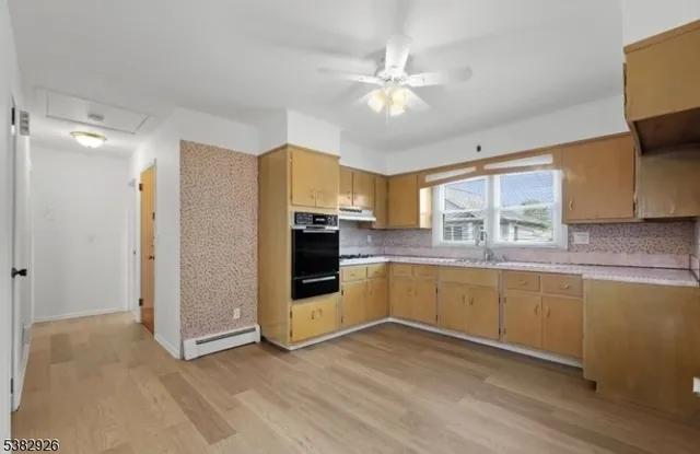 a kitchen with stainless steel appliances a refrigerator sink and stove