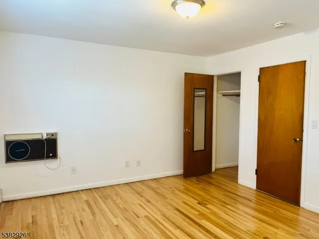 a view of an empty room and wooden floor