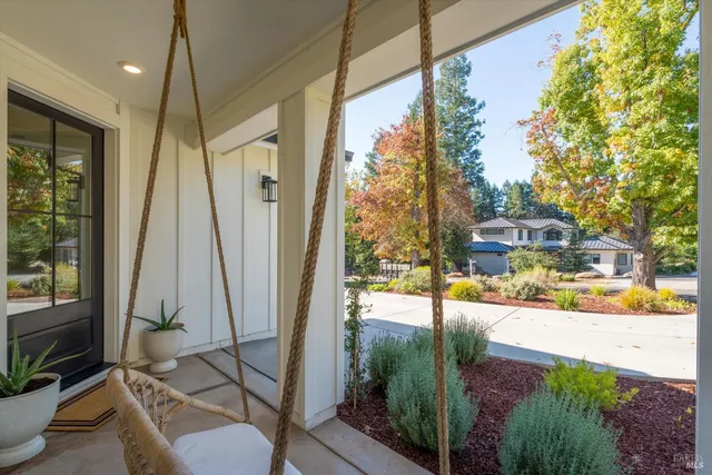 a view of a hallway view with wooden floor and a bathroom
