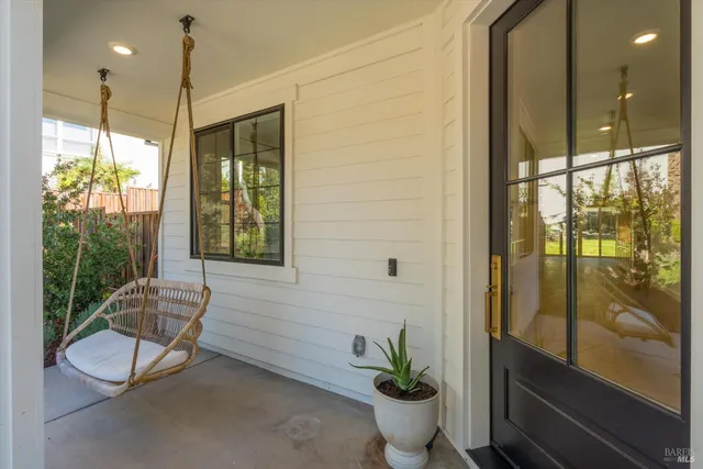 a view of a living room and kitchen with furniture and a large window