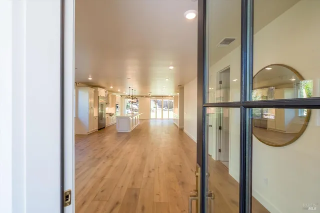 an empty room with windows and cabinet