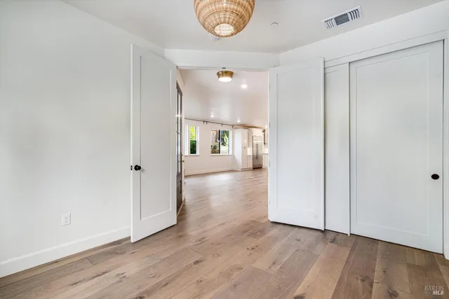 a bathroom with a sink a toilet a mirror and shower