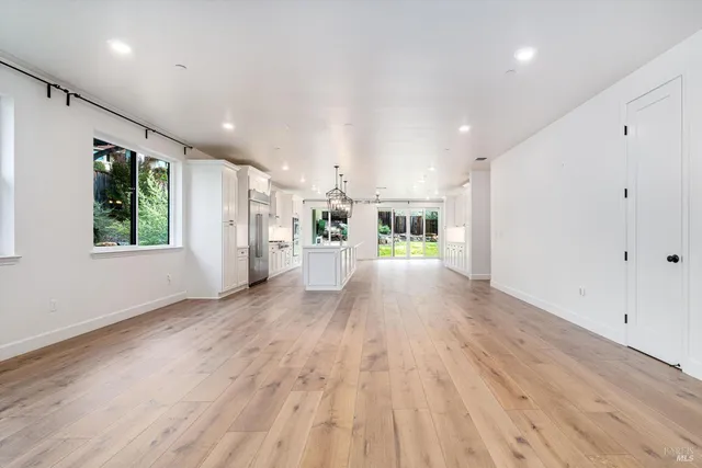 a view of a room with wooden floor and furniture