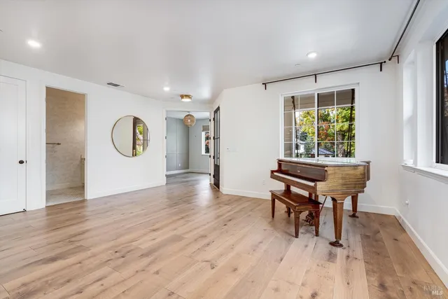 a view of an empty room with a fireplace and a window