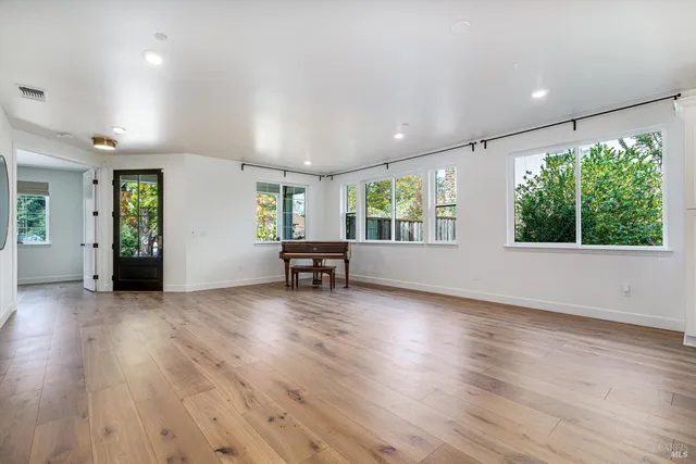 a view of an empty room with a fireplace and a window
