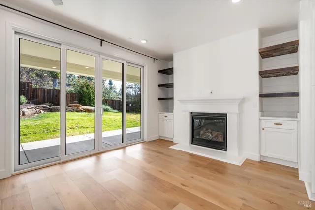 a view of a yard with plants and large trees