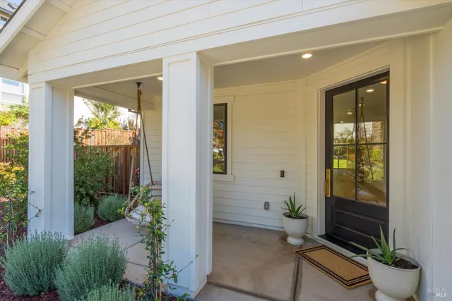a view of a hallway view with wooden floor and a bathroom