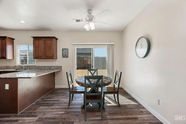 a view of a dining room with furniture and wooden floor