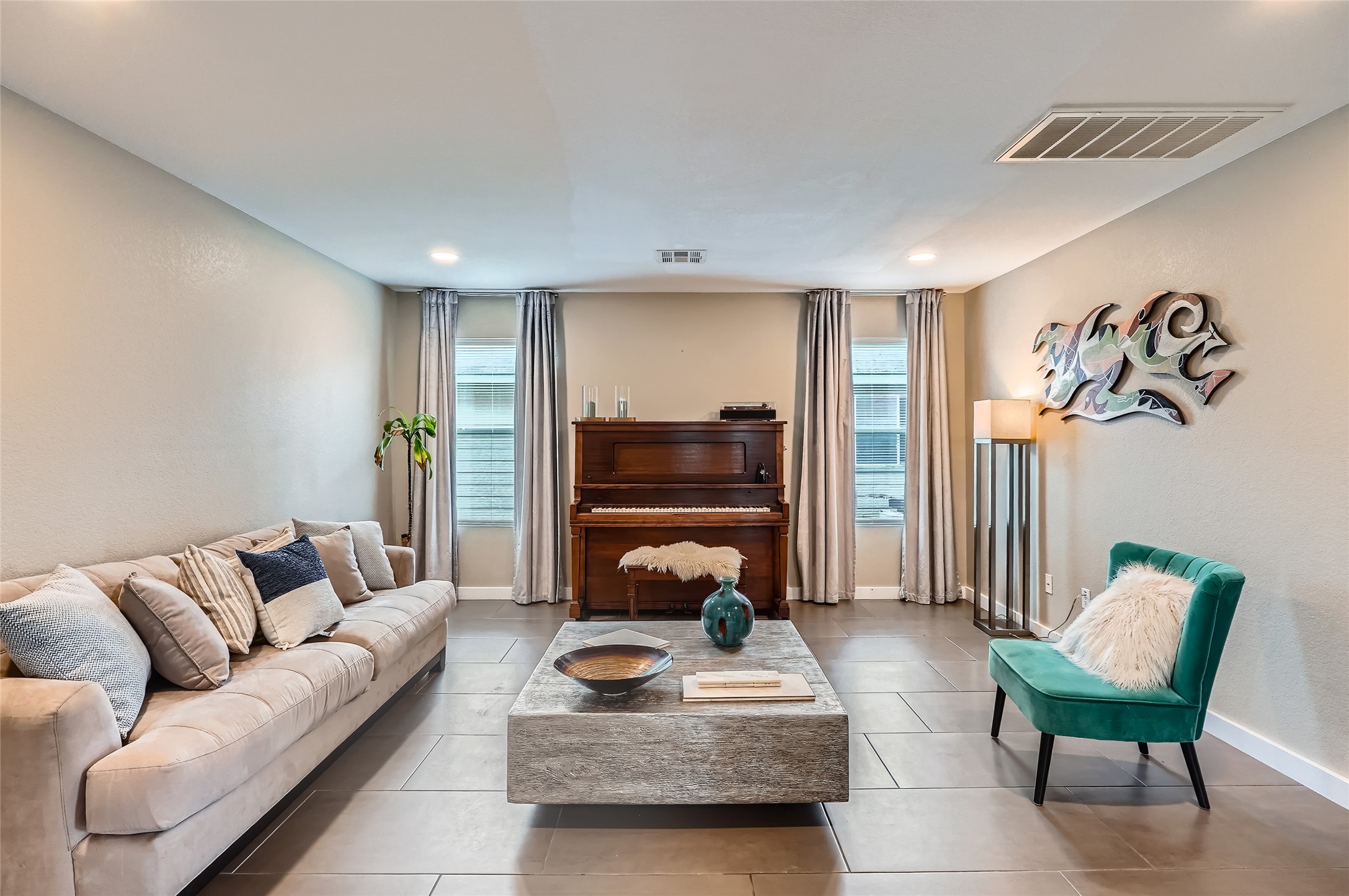 18021 Prairie Verbena Lane Elgin, TX 78621 - Photo 5 of 33 The generously sized living space is anchored by sleek tile flooring and recessed lighting.