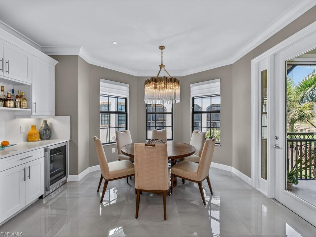 16371 Viansa Way, Unit 201 Naples, FL 34110 - Photo 11 of 42 a dining room with furniture a chandelier and window